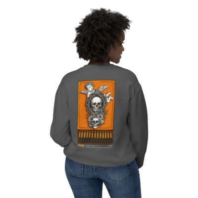 Back view of a woman wearing a grey unisex sweatshirt with a skull and pumpkin graphic for Halloween.